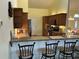 Open kitchen featuring granite countertops, wooden cabinets, and bar seating area at 4353 Hidden River Rd, Sarasota, FL 34240
