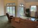 Cozy living room with sliding glass doors to lanai, comfortable seating, and green carpet at 4353 Hidden River Rd, Sarasota, FL 34240