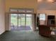 Bright living room with sliding glass doors to a screened-in patio and spacious backyard at 4353 Hidden River Rd, Sarasota, FL 34240
