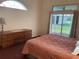 Bedroom with bed, dresser, and access to a screened outdoor area at 4353 Hidden River Rd, Sarasota, FL 34240