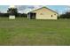 The rear of the home showcases a screened lanai and a large, green backyard at 4353 Hidden River Rd, Sarasota, FL 34240