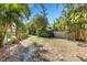 View of the expansive backyard, lined with tropical greenery and secure fencing at 4473 Diamond S Cir, Sarasota, FL 34233