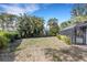 Large backyard with screen enclosed porch and mature landscaping in a tropical setting at 4473 Diamond S Cir, Sarasota, FL 34233