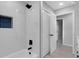 Updated bath/shower combo with tile surround, matte black fixtures, and recessed blue-tile accent at 4473 Diamond S Cir, Sarasota, FL 34233