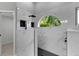 Newly remodeled walk-in shower with black fixtures and bright lighting and an arched window at 4473 Diamond S Cir, Sarasota, FL 34233