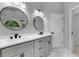 Modern bathroom featuring dual sinks, white marble floor, and two matching black framed mirrors at 4473 Diamond S Cir, Sarasota, FL 34233