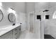 Modern bathroom with double vanity, sleek fixtures, a walk-in shower, and gray cabinetry at 4473 Diamond S Cir, Sarasota, FL 34233