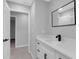 Bright bathroom showcasing a vanity with a large mirror and matte black faucet and hardware at 4473 Diamond S Cir, Sarasota, FL 34233