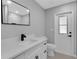Modern bathroom featuring sleek vanity, matte black fixtures, and a door leading to the outside at 4473 Diamond S Cir, Sarasota, FL 34233