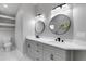 Bright bathroom featuring a double sink vanity with black hardware and modern mirrors at 4473 Diamond S Cir, Sarasota, FL 34233