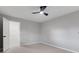 Bedroom with a ceiling fan, neutral carpet, and access to a walk-in closet at 4473 Diamond S Cir, Sarasota, FL 34233