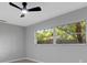 Bedroom featuring a large window with outdoor views and a ceiling fan at 4473 Diamond S Cir, Sarasota, FL 34233
