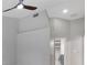 Neutral room featuring tall ceiling, ceiling fan, and view of bathroom entrance at 4473 Diamond S Cir, Sarasota, FL 34233