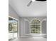 Bright bedroom showcasing arched window and shutter combination, and pool view at 4473 Diamond S Cir, Sarasota, FL 34233
