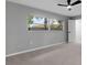 Bedroom with a large window offering natural light and views of the neighborhood at 4473 Diamond S Cir, Sarasota, FL 34233