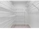 Walk-in closet with custom white shelving for ample storage space at 4473 Diamond S Cir, Sarasota, FL 34233