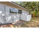 Exterior home view featuring a window, white fence and paved patio at 4473 Diamond S Cir, Sarasota, FL 34233