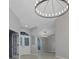 Bright foyer featuring a decorative light fixture, tile flooring and white doors with patterned windows at 4473 Diamond S Cir, Sarasota, FL 34233