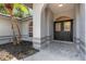 Elegant entryway showcasing double front doors with glass panels, an archway and a manicured garden at 4473 Diamond S Cir, Sarasota, FL 34233
