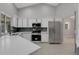 Bright kitchen with white cabinets, stainless steel appliances, and tile backsplash at 4473 Diamond S Cir, Sarasota, FL 34233