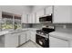 Bright modern kitchen featuring quartz countertops, stainless steel appliances, and a tiled backsplash at 4473 Diamond S Cir, Sarasota, FL 34233