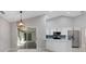 Well-lit open kitchen featuring stainless steel appliances, white cabinets, and a patio view at 4473 Diamond S Cir, Sarasota, FL 34233