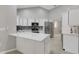 Bright kitchen with white cabinets, stainless steel appliances, and island at 4473 Diamond S Cir, Sarasota, FL 34233