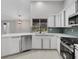 Modern kitchen featuring white cabinets, stainless steel appliances and a tiled backsplash at 4473 Diamond S Cir, Sarasota, FL 34233