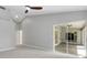 Spacious living room with tall ceilings, and sliding glass doors to a sunroom at 4473 Diamond S Cir, Sarasota, FL 34233