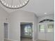 Spacious living room highlighting high ceilings, modern lighting, and bright interiors at 4473 Diamond S Cir, Sarasota, FL 34233