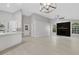 Open-concept layout with island, modern lighting, fireplace and lots of natural light at 4473 Diamond S Cir, Sarasota, FL 34233