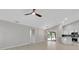 Open-concept living room and kitchen with light wood floors and vaulted ceilings at 4473 Diamond S Cir, Sarasota, FL 34233