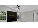 Bright living room with high ceilings, modern fireplace, and arched windows at 4473 Diamond S Cir, Sarasota, FL 34233
