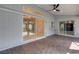 Covered patio with brick flooring, ceiling fan and sliding glass doors to indoor living space at 4473 Diamond S Cir, Sarasota, FL 34233