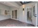 Covered patio showing pass-through window, sliding door to interior, and door to bathroom at 4473 Diamond S Cir, Sarasota, FL 34233