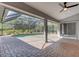 Back patio with a pool view, brick flooring, screened enclosure, and ceiling fan at 4473 Diamond S Cir, Sarasota, FL 34233