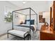 Bright bedroom featuring a four-poster bed, neutral tones, and ample natural light at 4492 Del Sol Blvd, Sarasota, FL 34243