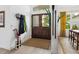 Welcoming foyer with hardwood floors, coat rack, and a view to the living space, creating a warm first impression at 4492 Del Sol Blvd, Sarasota, FL 34243