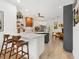 Bright open kitchen featuring a breakfast bar, stainless steel appliances, and hardwood accents at 4492 Del Sol Blvd, Sarasota, FL 34243