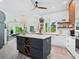 Modern kitchen featuring a large island, stainless steel appliances, and sleek white cabinets at 4492 Del Sol Blvd, Sarasota, FL 34243