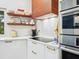 Updated kitchen with modern appliances, white cabinets, and a stylish wood range hood at 4492 Del Sol Blvd, Sarasota, FL 34243