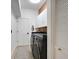 Modern laundry room features a front loading washer and dryer, white cabinets with gold hardware, and a gray accent rug at 4492 Del Sol Blvd, Sarasota, FL 34243