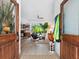 Open doorway leading to a stylish living room with modern furniture, a view of the pool, and natural light at 4492 Del Sol Blvd, Sarasota, FL 34243
