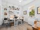Bright home office with built-in shelving, two desks, and abundant natural light at 4492 Del Sol Blvd, Sarasota, FL 34243