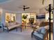 Welcoming covered patio with comfortable seating and outdoor entertainment, perfect for relaxation and gatherings at 4492 Del Sol Blvd, Sarasota, FL 34243