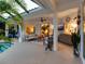 Elegant patio area showcases comfortable seating, a tranquil pool view, and lush landscaping, perfect for relaxing and entertaining at 4492 Del Sol Blvd, Sarasota, FL 34243