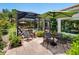 Inviting pool area with lush greenery, a covered patio, and an umbrella offering a serene outdoor experience at 4492 Del Sol Blvd, Sarasota, FL 34243