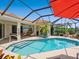 Beautiful pool boasts a screened enclosure, sun loungers, and seamless transition to the indoor living spaces at 4492 Del Sol Blvd, Sarasota, FL 34243