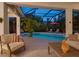 Relaxing screened pool area features outdoor seating and lush landscaping, seamlessly blending indoor and outdoor living at 4492 Del Sol Blvd, Sarasota, FL 34243