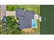 Aerial view of waterfront home with a private pool, dock, and well-maintained landscaping at 4506 17Th W St, Palmetto, FL 34221